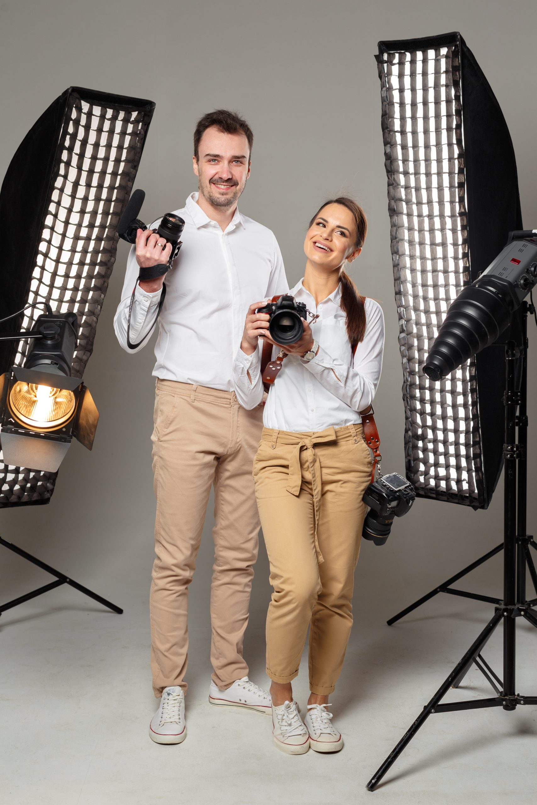 smiling young professional photographers posing studio 1 scaled
